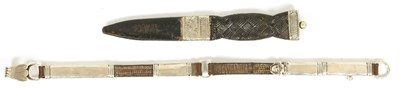 Lot 456 - A NIKEL AND LEATHER SGIAN DUBH AND A SILVER AND LEATHER SWORD HANGER