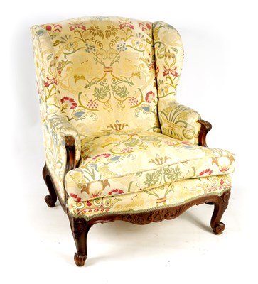 Lot 1074 - A LARGE 19TH CENTURY FRENCH CARVED WALNUT UPHOLSTERED WING ARMCHAIR