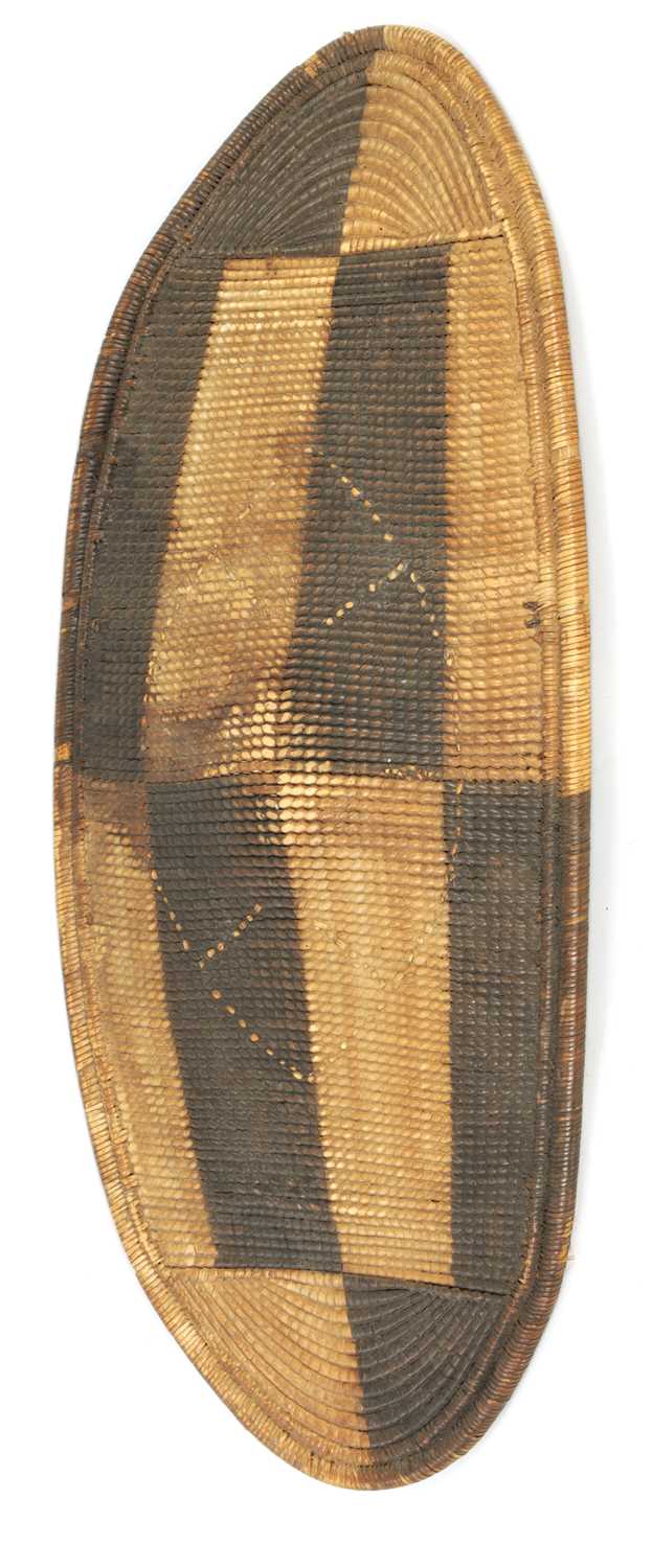 Lot 643 - A 19TH CENTURY AFRICAN WOVEN WICKER TRIBAL SHIELD