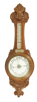 Lot 893 - AN EARLY 20TH CENTURY CARVED OAK ANEROID WHEEL BAROMETER