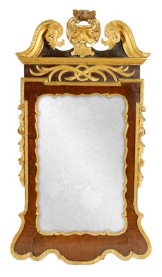 Lot 869 - A GEORGE II WALNUT AND PARCEL GILT HANGING MIRROR OF GENEROUS SIZE