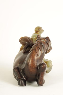 Lot 200 - AN EARLY CHINESE CARVED RUSSET JADE SCULPTURE OF A RECUMBENT HORSE AND THREE MONKEYS