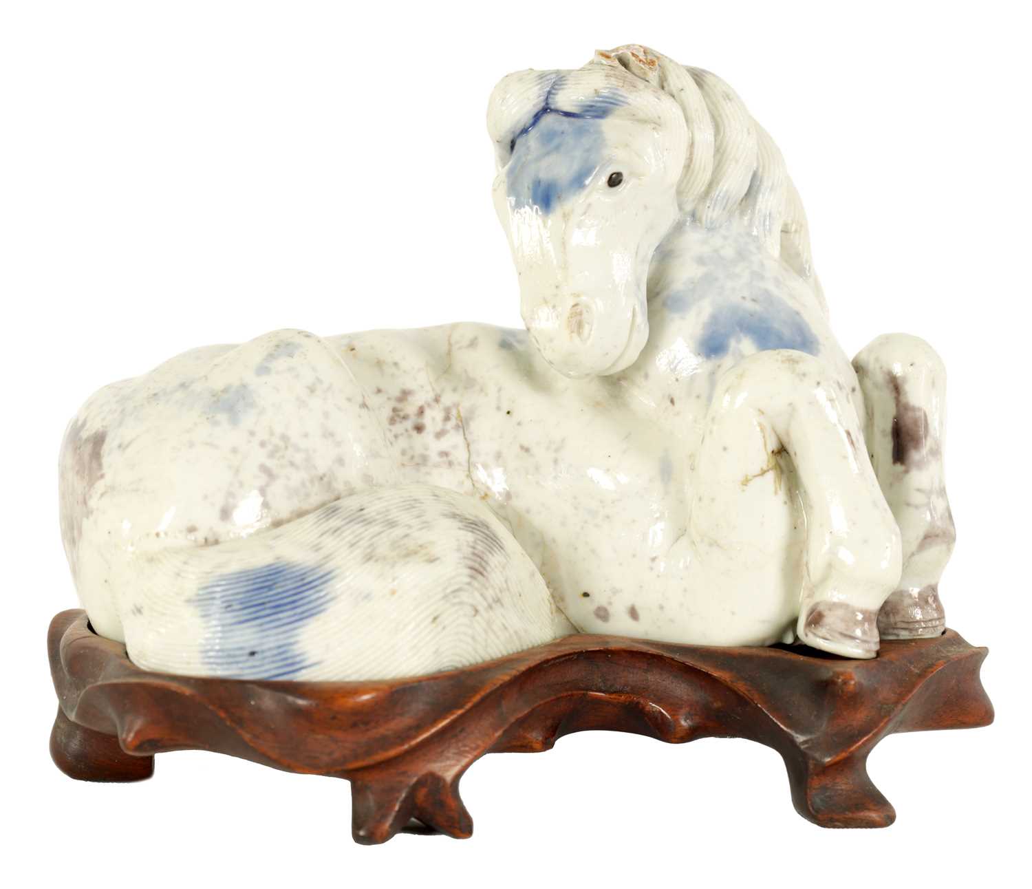 Lot 69 - A 19TH CENTURY CHINESE POTTERY WHITE AND BLUE SPASH GLAZED SCULPTURE OF A RECUMBENT HORSE