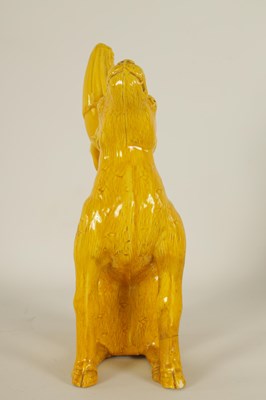 Lot 96 - A 19TH CENTURY CHINESE POTTERY YELLEW GLAZE MODEL OF GUANYIN MOUNTED ON A DEER
