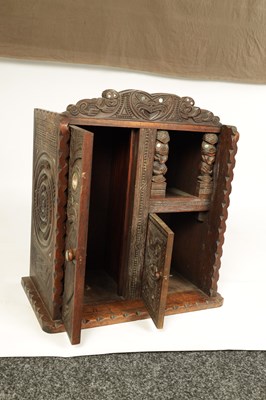 Lot 949 - A MID 20TH CENTURY NEW ZEALAND MAOIRE CARVED HARDWOOD CABINET