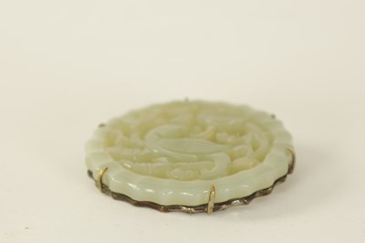 Lot 89 - A CHINESE CARVED JADE BROOCH