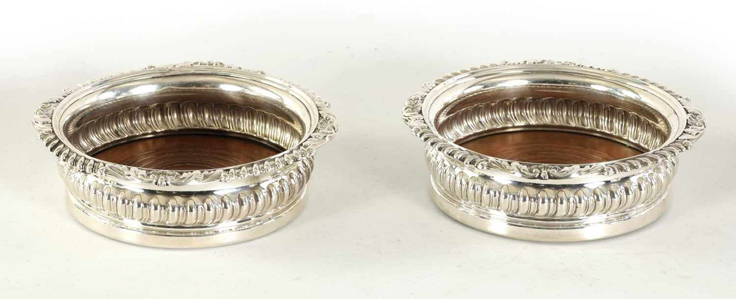 Lot 328 - A PAIR OF GEORGE IV OVERSIZED SILVER WINE COASTERS