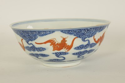 Lot 141 - A CHINESE GUANGXI PERIOD IRON-RED-DECORATED BLUE AND WHITE BAT BOWL
