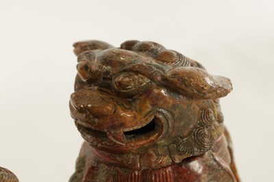 Lot 135 - AN EARLY CHINESE CARVED SOAPSTONE SCULPTURE OF A LIDDED FOO DOG