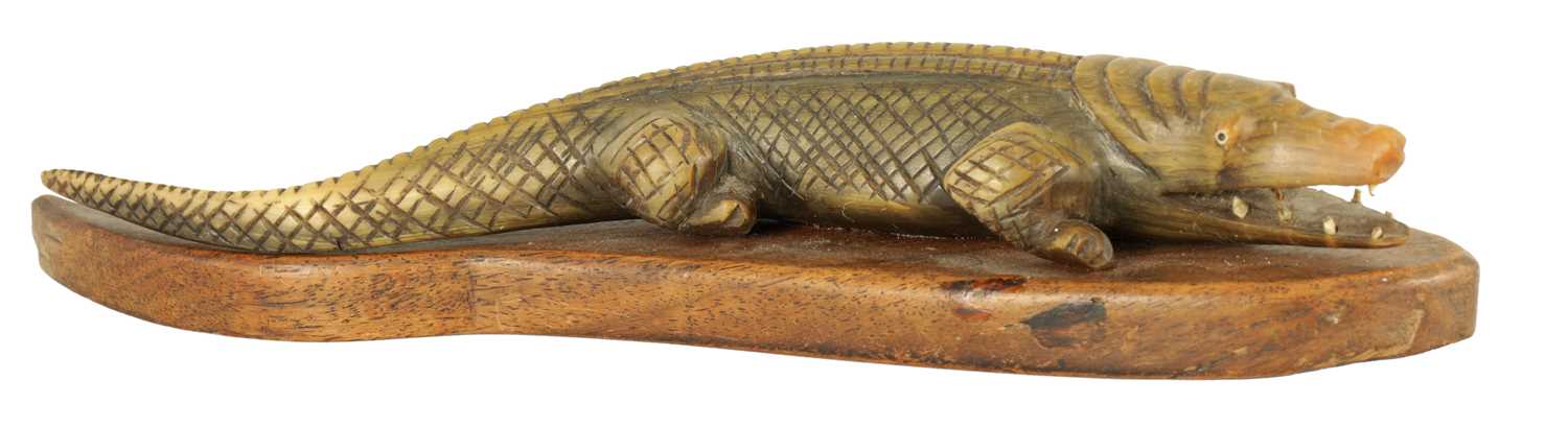 Lot 111 - A LATE 19TH CENTURY CARVED HORN CROCODILE SCULPTURE