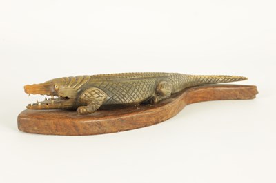 Lot 111 - A LATE 19TH CENTURY CARVED HORN CROCODILE SCULPTURE