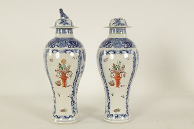 Lot 184 - A PAIR OF 19TH CENTURY CHINESE FAMILLE ROSE BLUE AND WHITE SLENDER INVERTED BALUSTER VASES AND COVERS