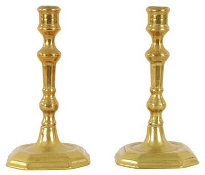 Lot 403 - A PAIR OF EARLY GEORGIAN CAST BRASS CANDLESTICKS