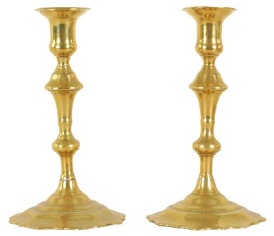 Lot 407 - A PAIR OF EARLY GEORGIAN CAST BRASS CANDLESTICKS