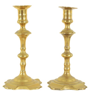 Lot 410 - A NEAR PAIR OF EARLY GEORGIAN CAST BRASS CANDLESTICKS OF LARGE SIZE