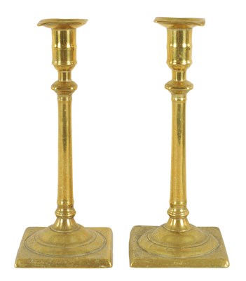 Lot 408 - A PAIR OF GEORGE III CAST BRASS CANDLESTICKS