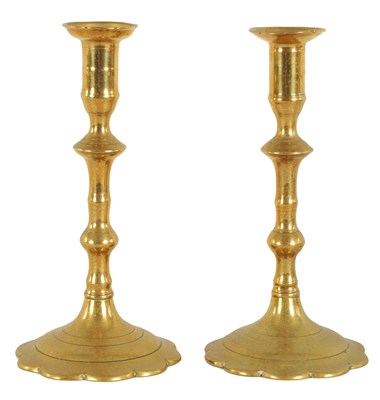 Lot 412 - A PAIR OF EARLY GEORGE III CAST BRASS CANDLESTICKS