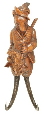 Lot 596 - A LATE 19TH CENTURY BLACK FOREST CARVED LINDENWOOD COAT HOOK