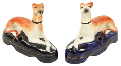 Lot 1404 - A PAIR OF 19TH CENTURY STAFFORDSHIRE RECUMBENT HOUNDS