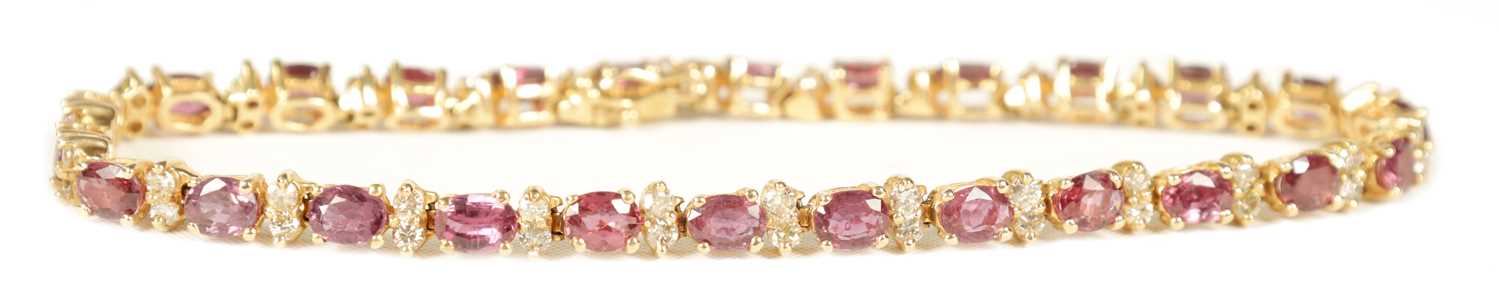Lot 248 - A LADIES 14CT YELLOW GOLD RUBY AND DIAMOND TENNIS BRACELET