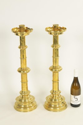 Lot 10 - A PAIR OF LATE 19TH CENTURY BRASS OVERSIZED GOTHIC STYLE CANDLESTICKS