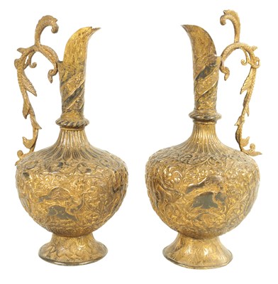 Lot 193 - A PAIR OF 19TH CENTURY INDIAN GILT METAL EWERS