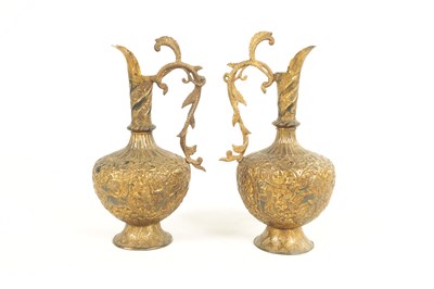 Lot 193 - A PAIR OF 19TH CENTURY INDIAN GILT METAL EWERS