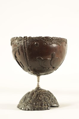 Lot 548 - AN 18TH CENTURY CARVED COCONUT SHELL ON STAND