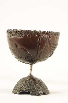 Lot 548 - AN 18TH CENTURY CARVED COCONUT SHELL ON STAND