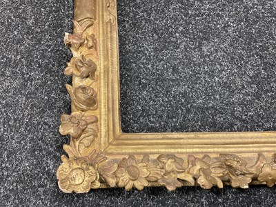 Lot 1050 - AN 18TH CENTURY LEAF CARVED GILT FRAME