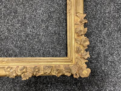 Lot 1050 - AN 18TH CENTURY LEAF CARVED GILT FRAME