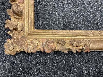 Lot 1050 - AN 18TH CENTURY LEAF CARVED GILT FRAME