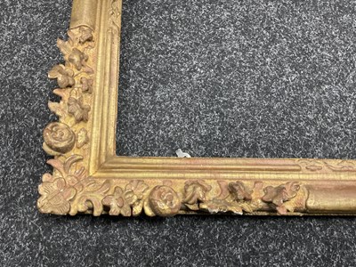 Lot 1050 - AN 18TH CENTURY LEAF CARVED GILT FRAME