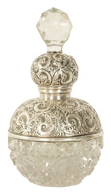 Lot 55 - A GEORGE V SILVER TOPPED CUT GLASS PERFUME BOTTLE