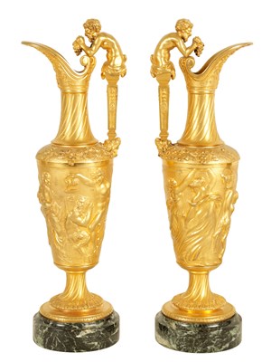 Lot 449 - A GOOD PAIR OF 19TH CENTURY FRENCH GILT BRONZE EWERS ON VEINED GREEN MARBLE BASES