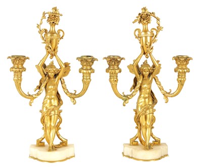 Lot 525 - AN ORNATE PAIR OF 19TH CENTURY FRENCH GILT ORMOLU TWO BRANCH FIGURAL CANDELABRA