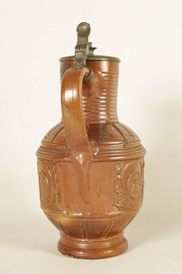 Lot 72 - A LATE 16TH CENTURY GERMAN BROWN SALT GLAZED STONEWARE JUG DATED 1598 WITH HINGED PEWTER COVER