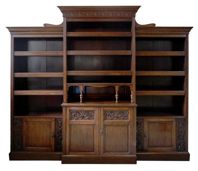 Lot 1240 - AN EDWARDIAN OAK BREAK-FRONT BOOK CASE