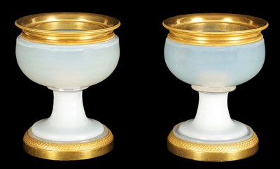 Lot 644 - A PAIR OF EARLY 19TH CENTURY FRENCH ORMOLU MOUNTED WHITE OPALINE GLASS CUPS