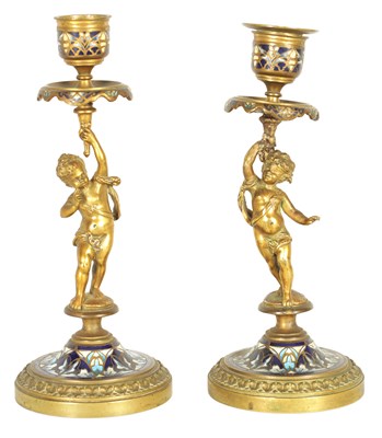 Lot 729 - A PAIR OF 19TH CENTURY FRENCH FIGURAL GILT BRONZE AND CHAMPLEVE ENAMEL CANDLESTICKS