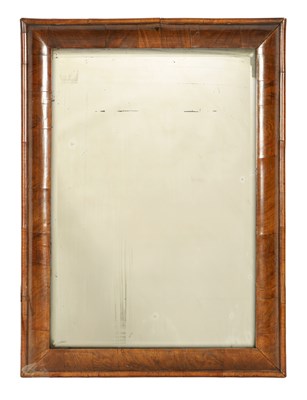 Lot 1097 - A WILLIAM AND MARY FIGURED WALNUT CUSHION FRAMED HANGING MIRROR