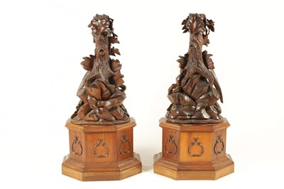 Lot 585 - A LARGE PAIR OF LATE 19TH CENTURY CARVED BLACK FOREST CANDLE STANDS
