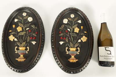 Lot 677 - A PAIR OF 19TH CENTURY ITALIAN BLACK SLATE AND PIETRA DURA SLENDER OVAL HANGING PLAQUES