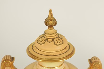 Lot 52 - AN ORNATE ROYAL WORCESTER GILT AND IVORY GROUND SCROLLED TWO-HANDLED CABINET VASE AND COVER