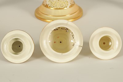 Lot 52 - AN ORNATE ROYAL WORCESTER GILT AND IVORY GROUND SCROLLED TWO-HANDLED CABINET VASE AND COVER