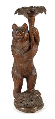 Lot 558 - A LATE 19TH CENTURY CARVED BLACK FOREST BEAR JARDINIERE STAND