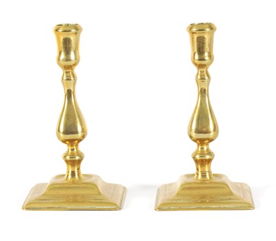 Lot 506 - A PAIR OF MID 18TH CENTURY CAST BRASS CANDLESTICKS