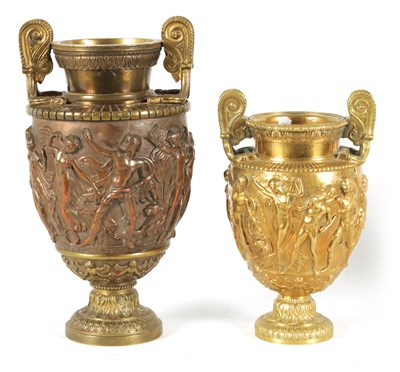 Lot 719 - TWO 19TH CENTURY FRENCH BRASS AND COPPER ROMANESQUE TWO-HANDLED URNS