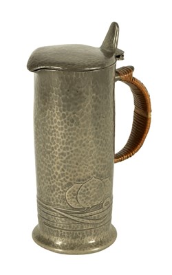 Lot 550 - AN ART NOVEAU TUDRIC PEWTER PLANISHED LIDDED JUG WITH BASKET WEAVE HANDLE IN THE MANNER OF ARCHIBALD KNOX