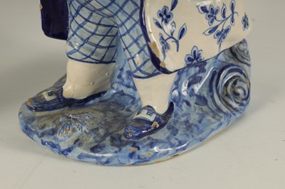 Lot 60 - THREE 18TH CENTURY BLUE AND WHITE DELFTWARE TOBY JUGS